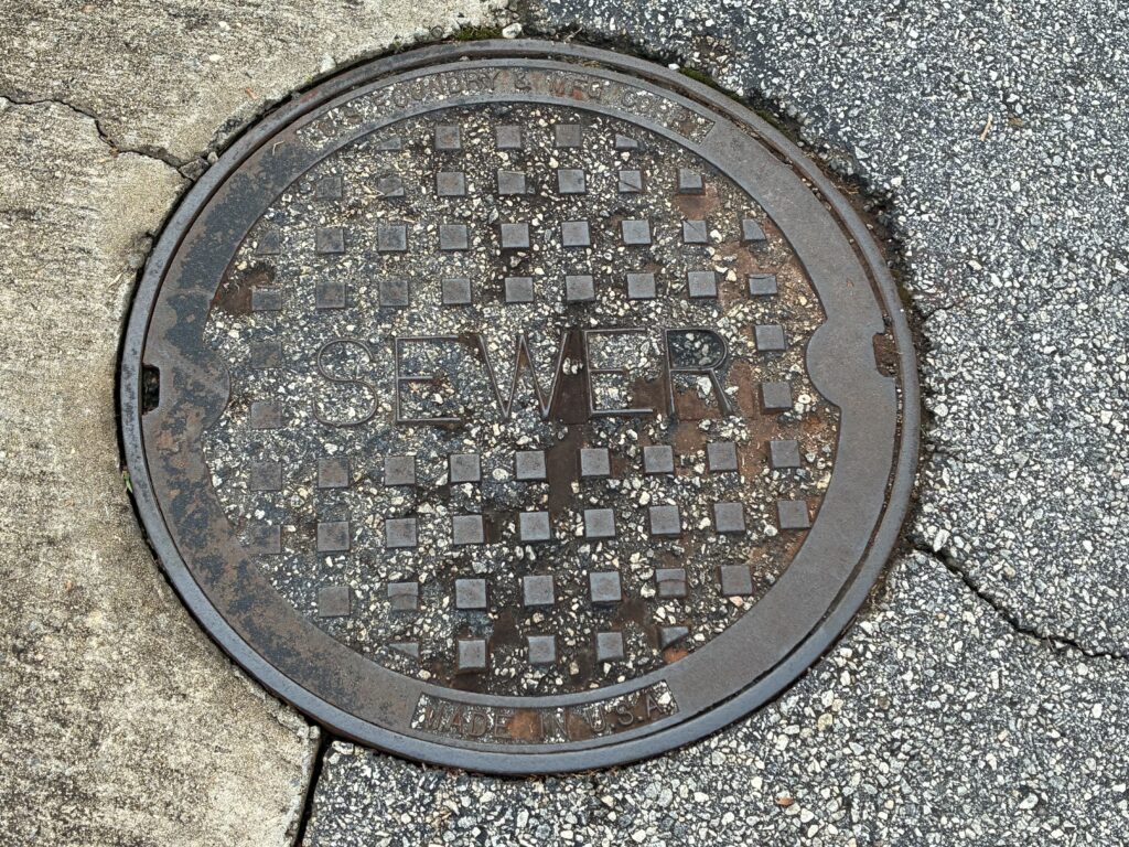 iPhone 16e sewer drain manhole