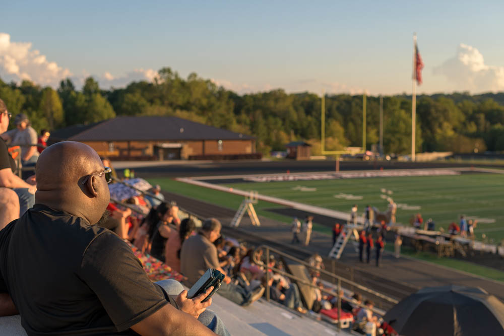 Spectator in bleachers, enjoying the event